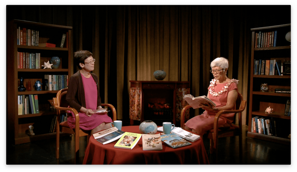 Juliet S. Kono reads an excerpt from her book. Ann Inoshita attentively listens